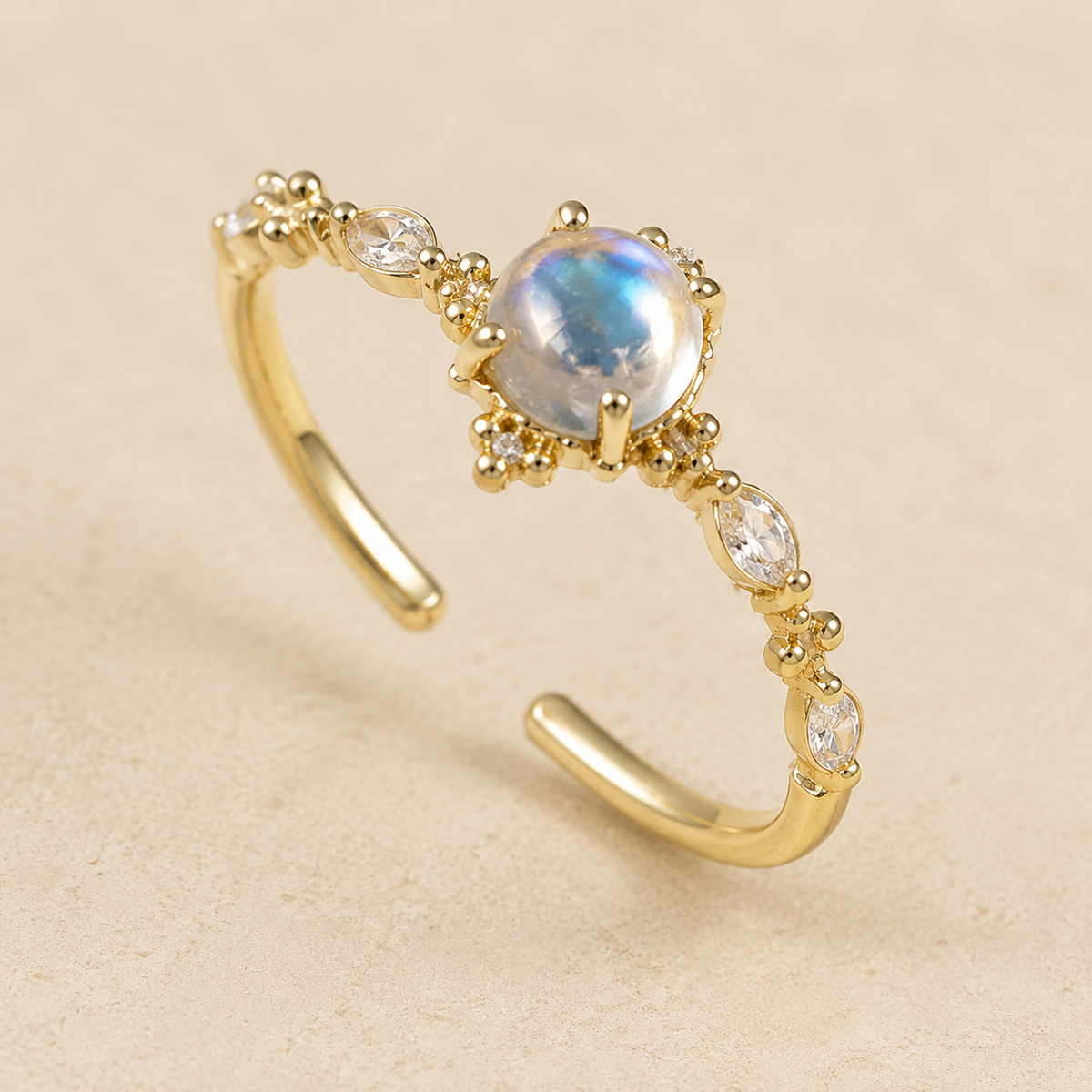 Luna Moonstone Open Ring on a warm ivory studio background