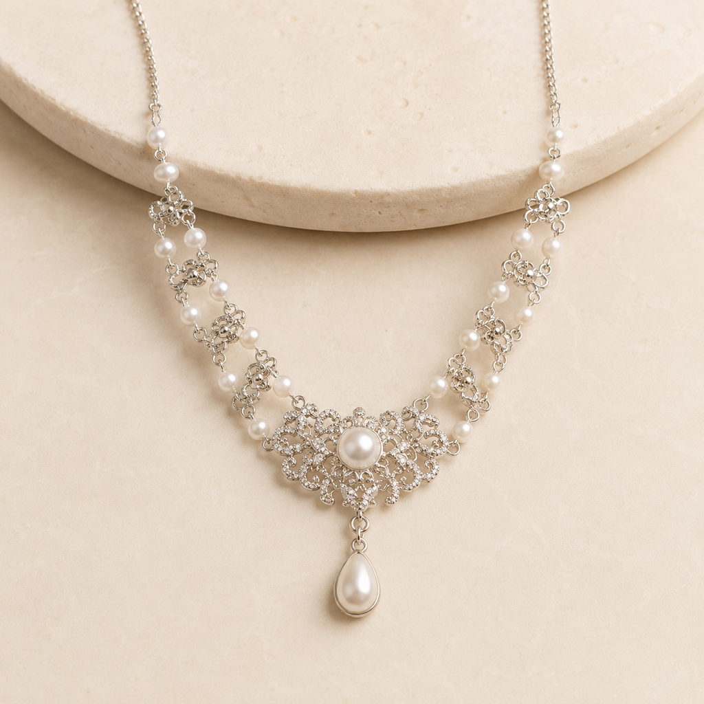 Celeste Pearl Teardrop Statement Necklace on a warm ivory studio background