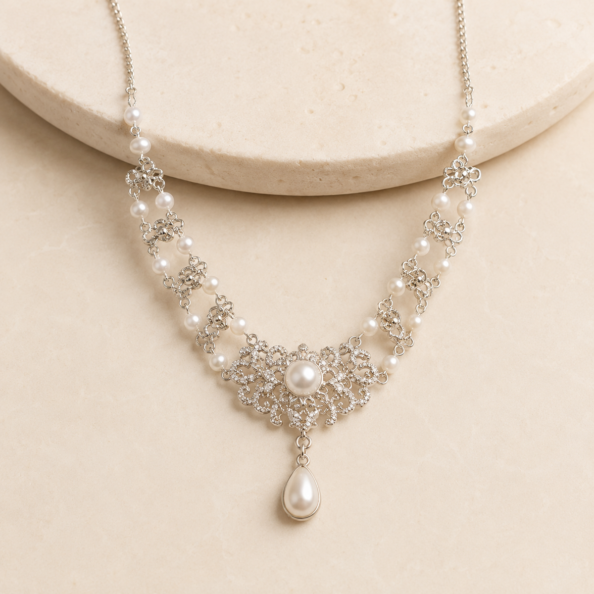 Celeste Pearl Teardrop Statement Necklace on a warm ivory studio background