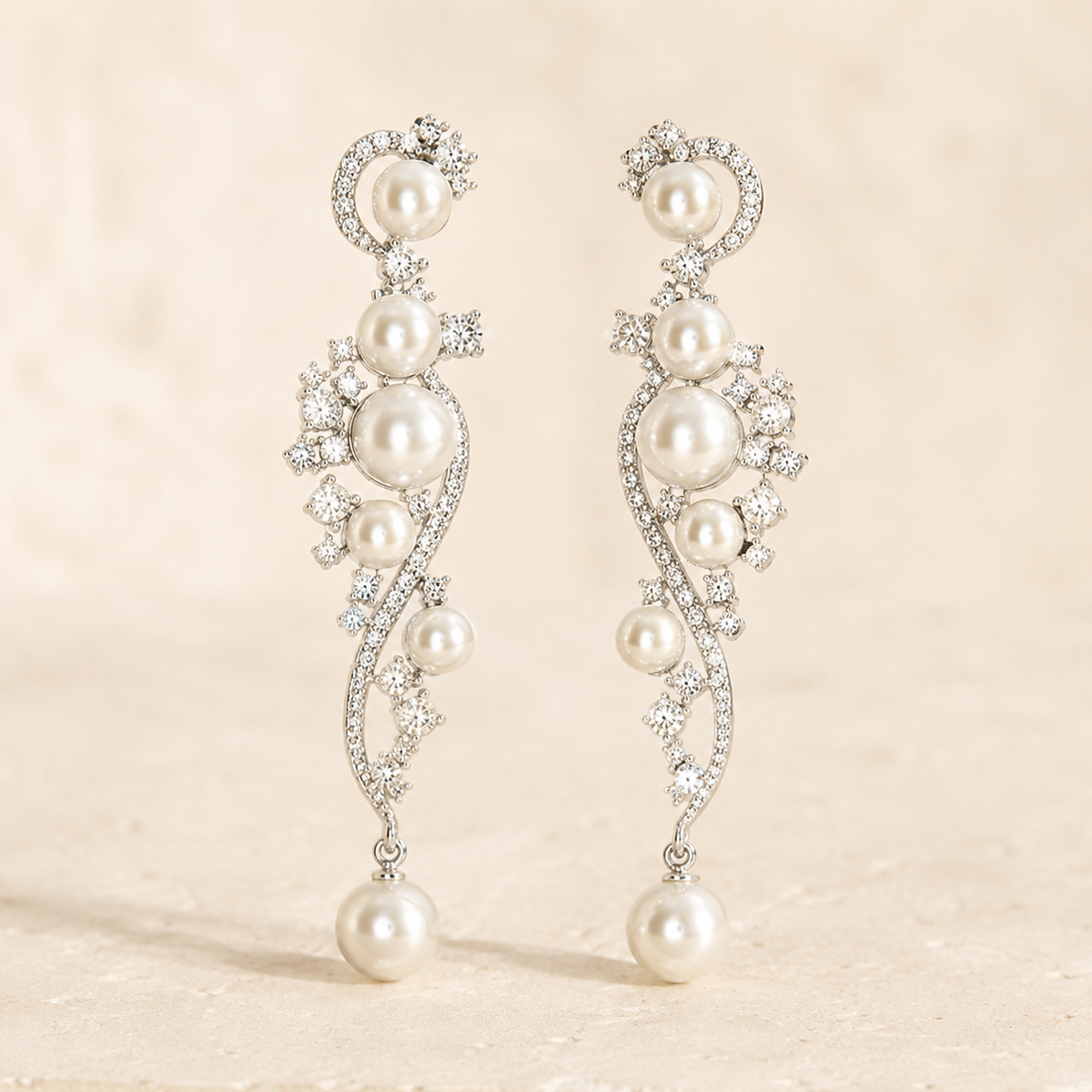Opaline Pearl Cascade Earrings on a warm ivory studio background