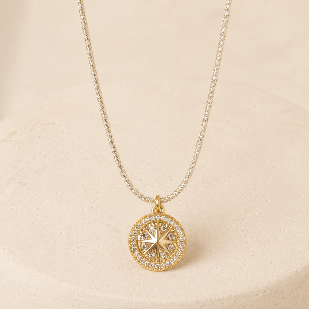 Astral Star Medallion Necklace on a warm ivory studio background