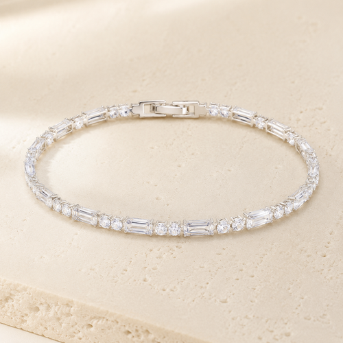 Rivière Crystal Tennis Bracelet on a warm ivory studio background
