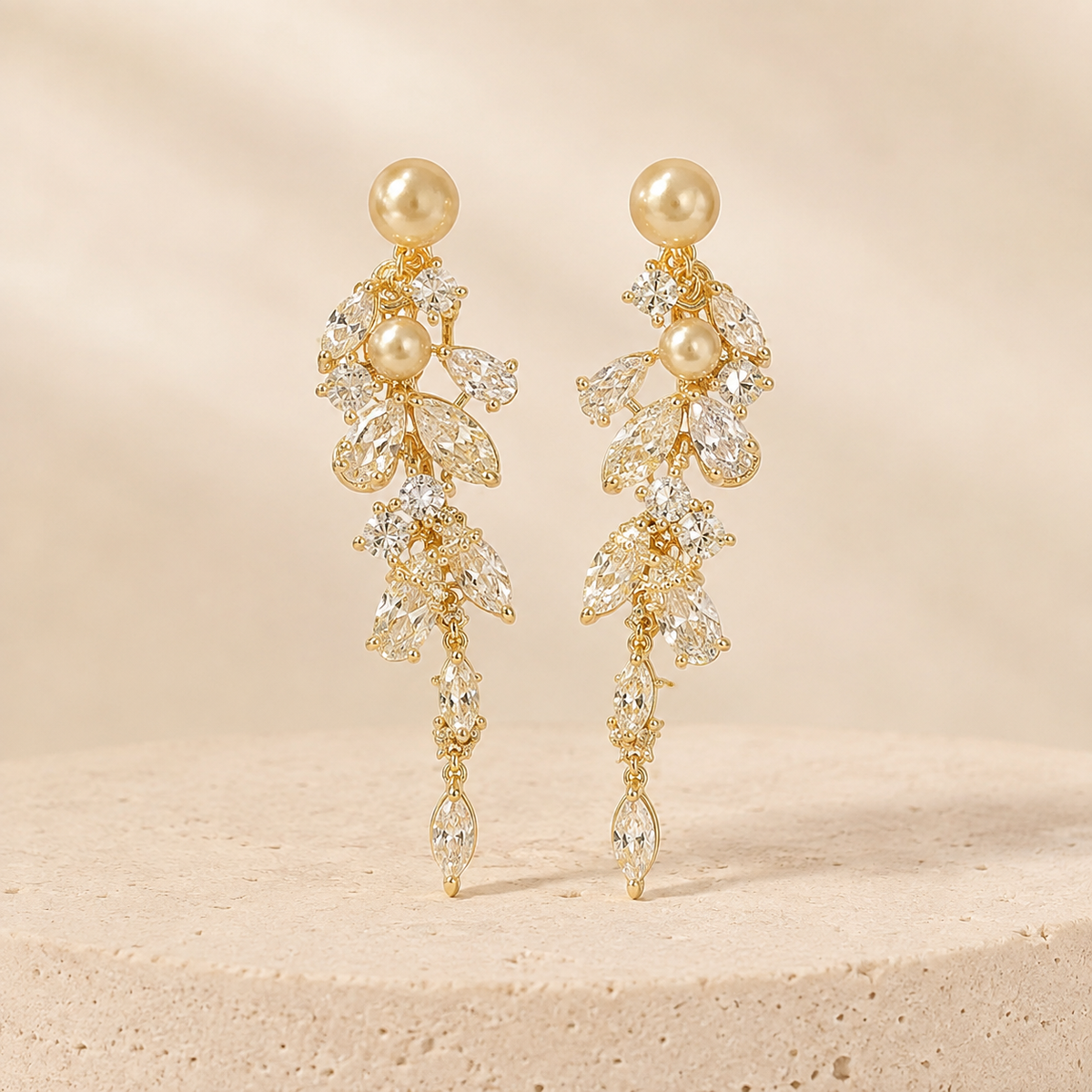 Champagne Leaf & Pearl Drop Earrings on a warm ivory studio background