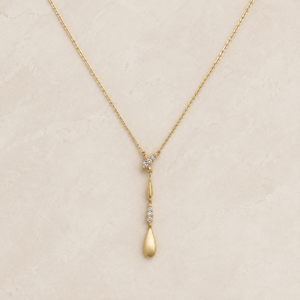Solenne Y-Drop Necklace on a warm ivory studio background