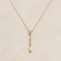 Solenne Y-Drop Necklace on a warm ivory studio background