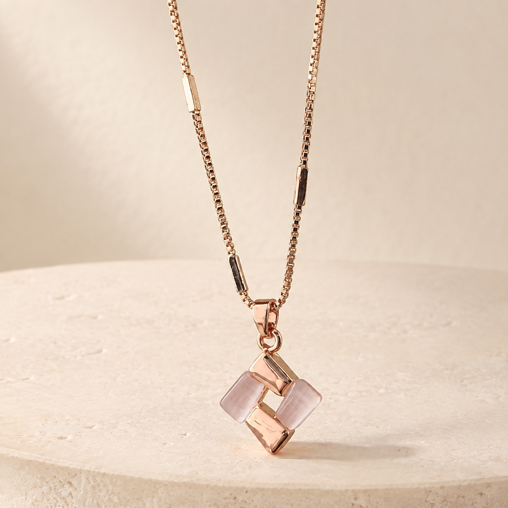 Rosé Geometric Pendant Necklace on a warm ivory studio background